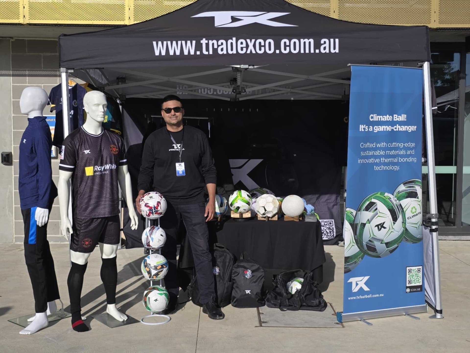 TradexCo marquee setup with custom sportswear and footballs